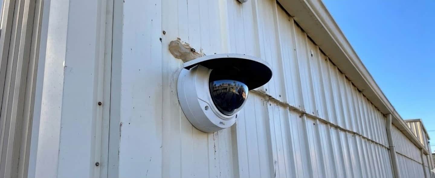 Modern Axis security cameras mounted on Florida commercial building exterior