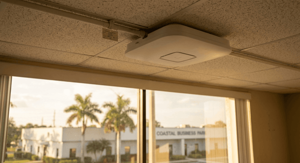 Commercial wireless access point cleanly mounted on office ceiling